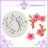 Floral silicone mold with cherry blossom branches and pink flower decorations for cakes, cupcakes, fondant, and confectionery decorating.