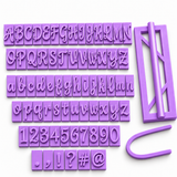 Purple elegant script alphabet fondant cutter set with uppercase and lowercase letters, numbers, punctuation and symbols for personalized cake decorating, gum paste, modeling chocolate and clay.