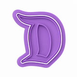 Enchanted Letter D cookie cutter and embosser two-piece set with decorated monogram sugar cookie