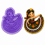 Royal Orchid Lavender Folklórico Dancer cookie cutter and embosser displayed beside a decorated sugar cookie featuring a traditional Mexican folklórico dancer with a colorful embroidered dress and marigold-inspired floral accents on a white backgroun