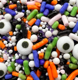 Ghoulish Goodies Halloween Sprinkle Mix featuring candy eyeballs, orange, purple, green, black, and white sprinkles for decorating cookies, cupcakes, cakes, cake pops, and Halloween treats.