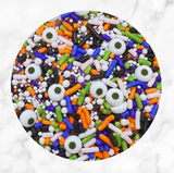 Ghoulish Goodies Halloween Sprinkle Mix featuring candy eyeballs, orange, purple, green, black, and white sprinkles for decorating cookies, cupcakes, cakes, cake pops, and Halloween treats.