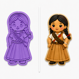 Royal Orchid Lavender Little Soldadera Cookie Cutter & Embosser Stamp Set displayed beside a hand-decorated sugar cookie featuring a cute Mexican Soldadera girl with braided hair, a traditional dress, and a bandolier on a clean white background.