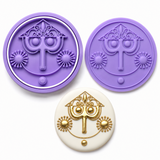Storybook clock tower cookie cutter and embosser set in Royal Orchid Lavender with matching decorated white cookie featuring elegant gold detailing.

Short Version
