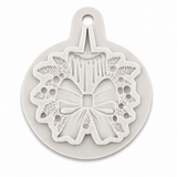 Christmas candle and bow silicone mold featuring detailed evergreen branches and berries.