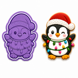 Royal Orchid Lavender Christmas Penguin with Holiday Lights Cookie Cutter & Embosser Two-Piece Set beside decorated sugar cookie on a white background.