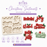 Christmas Sentiments silicone mold featuring seven festive holiday word and saying designs with finished Christmas decorations for chocolate, fondant, cakes, cupcakes, and holiday treats.