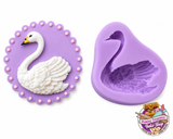 Elegant swan silicone mold with detailed feather design and finished white swan decoration for fondant, chocolate and cake decorating.