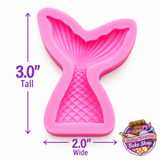 Colorful pink, turquoise and lavender mermaid tail cupcake toppers with seashells, pearls and sprinkles for an under the sea party.