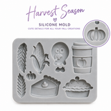 Harvest-themed silicone mold with finished fall decorations including turkey, corn, pumpkin coffee cup, wheat and pie designs.