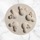 Mouse ears and bows silicone mold displayed with coordinating mouse-themed cake decorating examples for birthdays, baby showers, and children's celebrations.