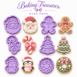 Pastel Christmas 6-piece cookie cutter set with Santa, gingerbread man, candy cane, Christmas tree, penguin, and wreath on a white background