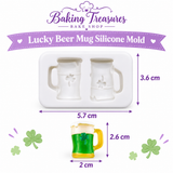 White 2-cavity St. Patrick's Day silicone mold featuring shamrock beer mugs, displayed with two finished green beer mug decorations with white foam and gold handles.