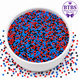 Superhero Web-Slinger Nonpareil Sprinkle Mix featuring bright blue, red, and black round edible sprinkles in a white bowl, perfect for superhero birthday cakes, cupcakes, cookies, and comic book-themed celebrations.